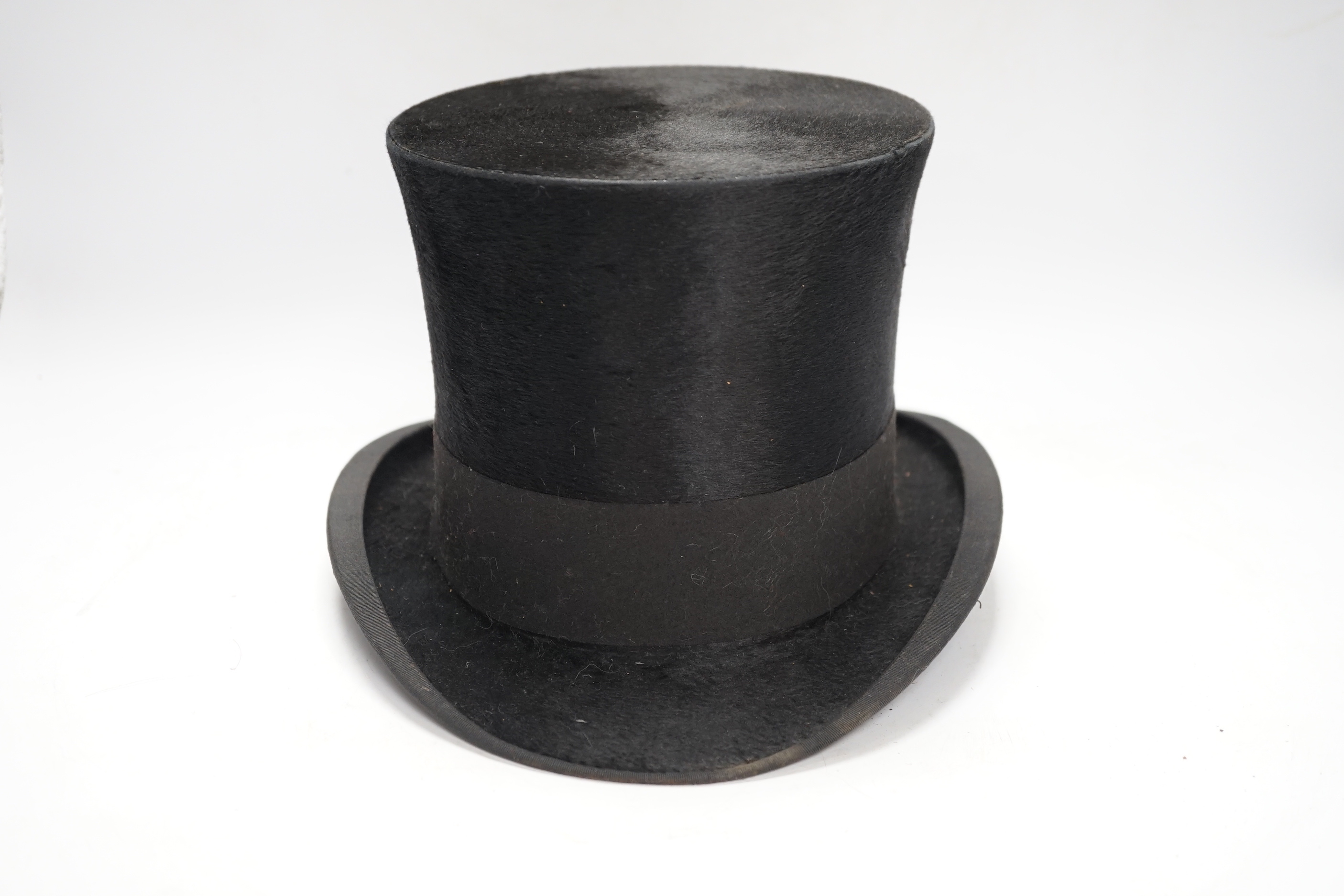 A top hat, in leather case
